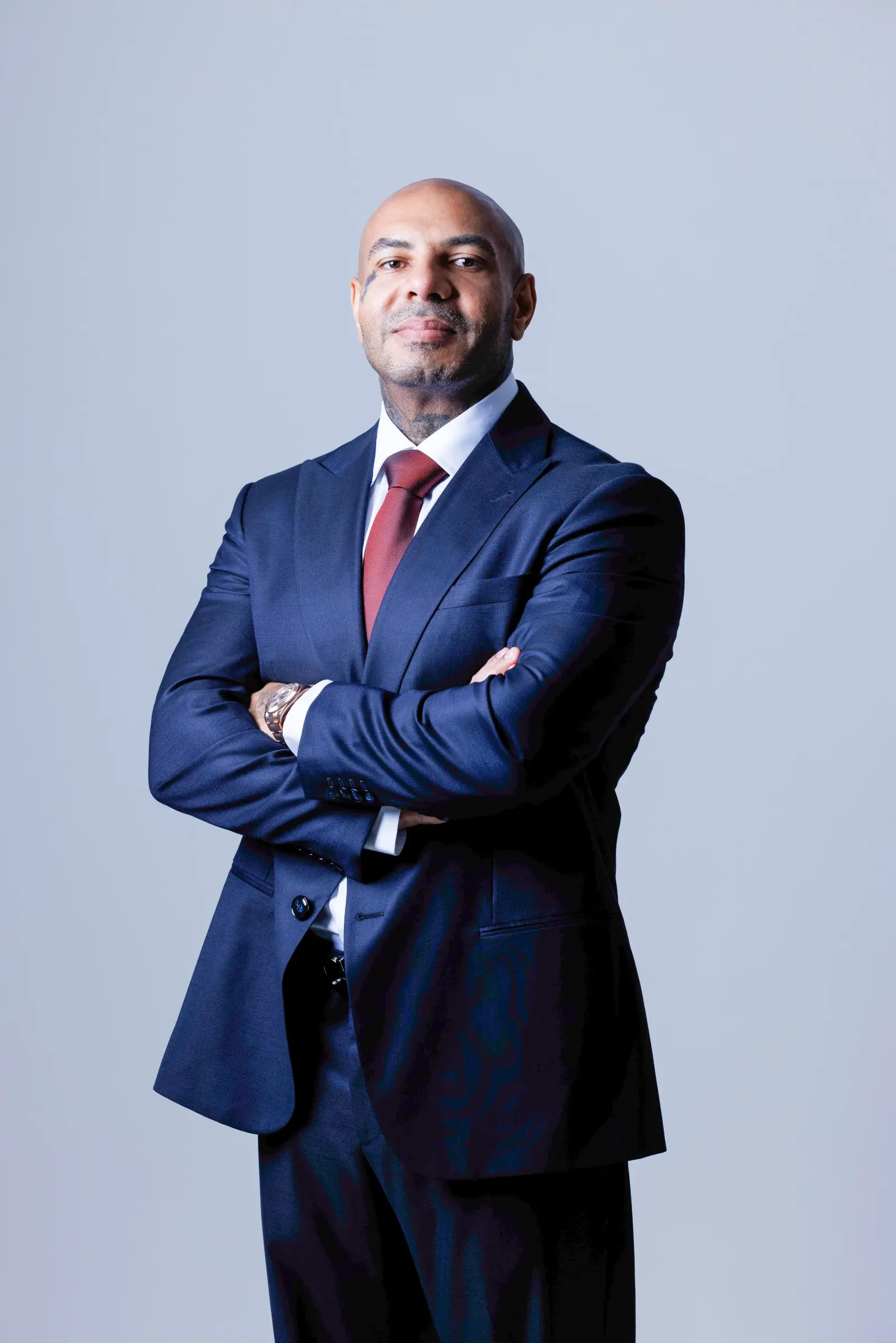 Karim Gharbi, arms crossed, in a dark suit