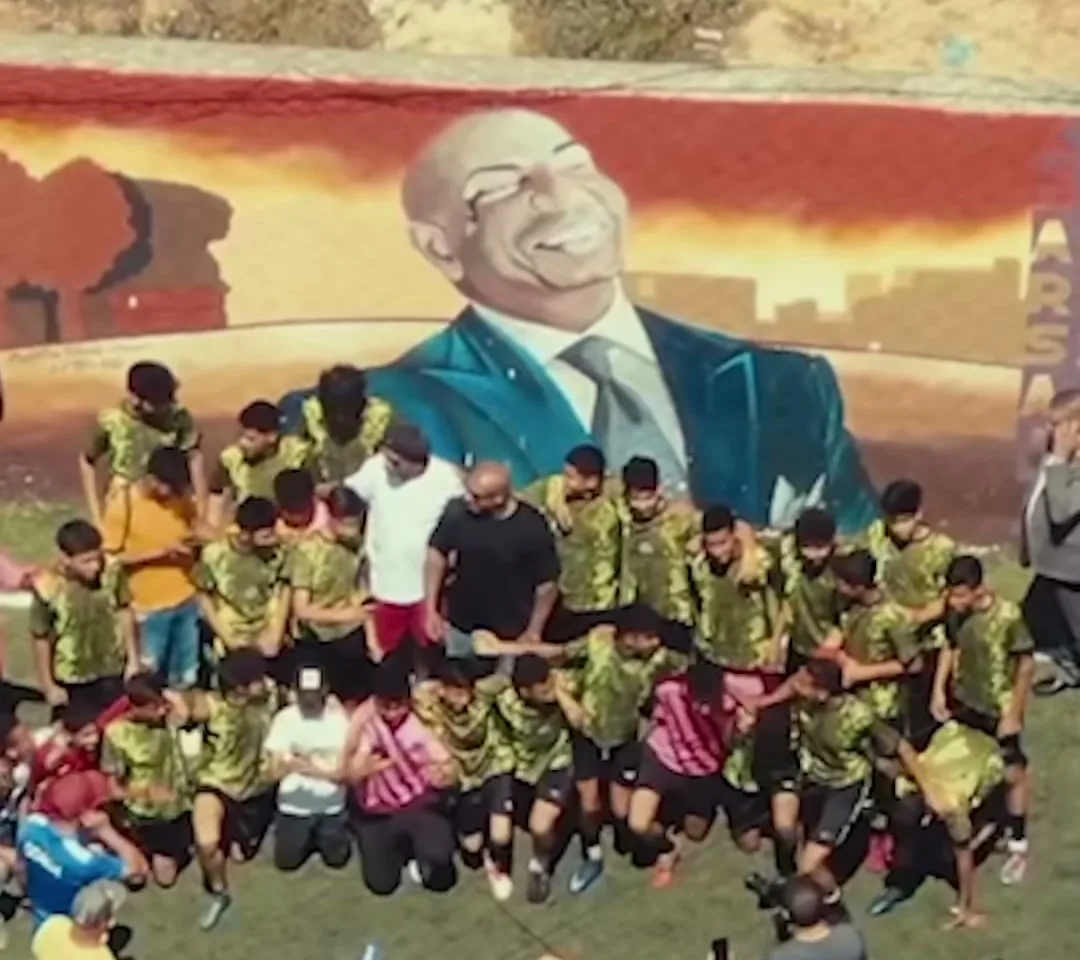 The Ksar Said pitch, with a mural of Karim Gharbi and the youth academy